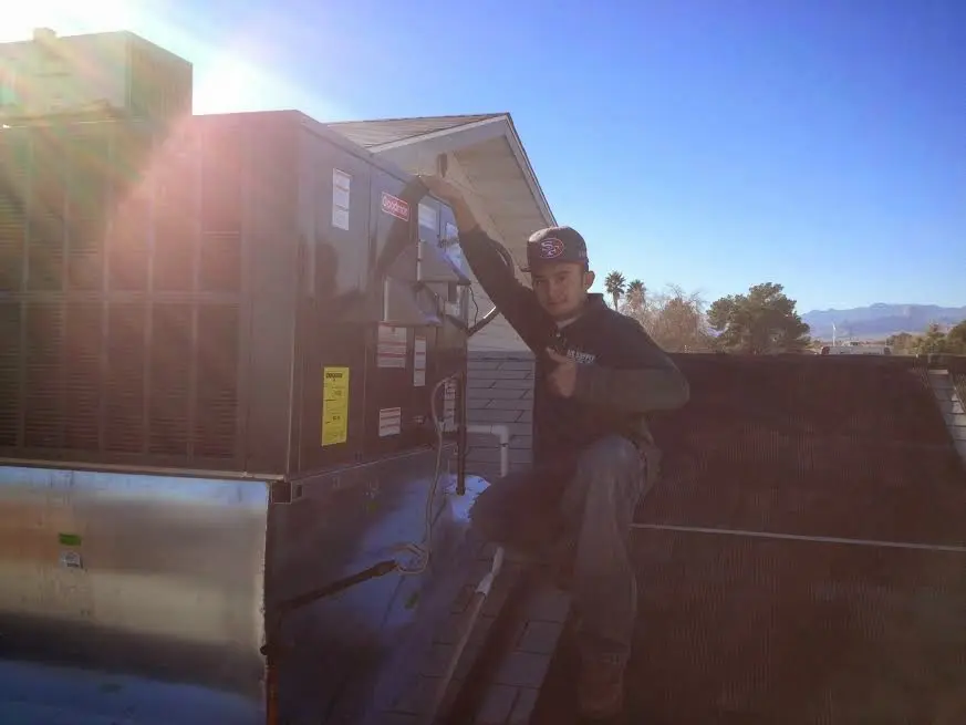 HVAC technician performing HVAC Inspection on a rooftop unit in Union City
